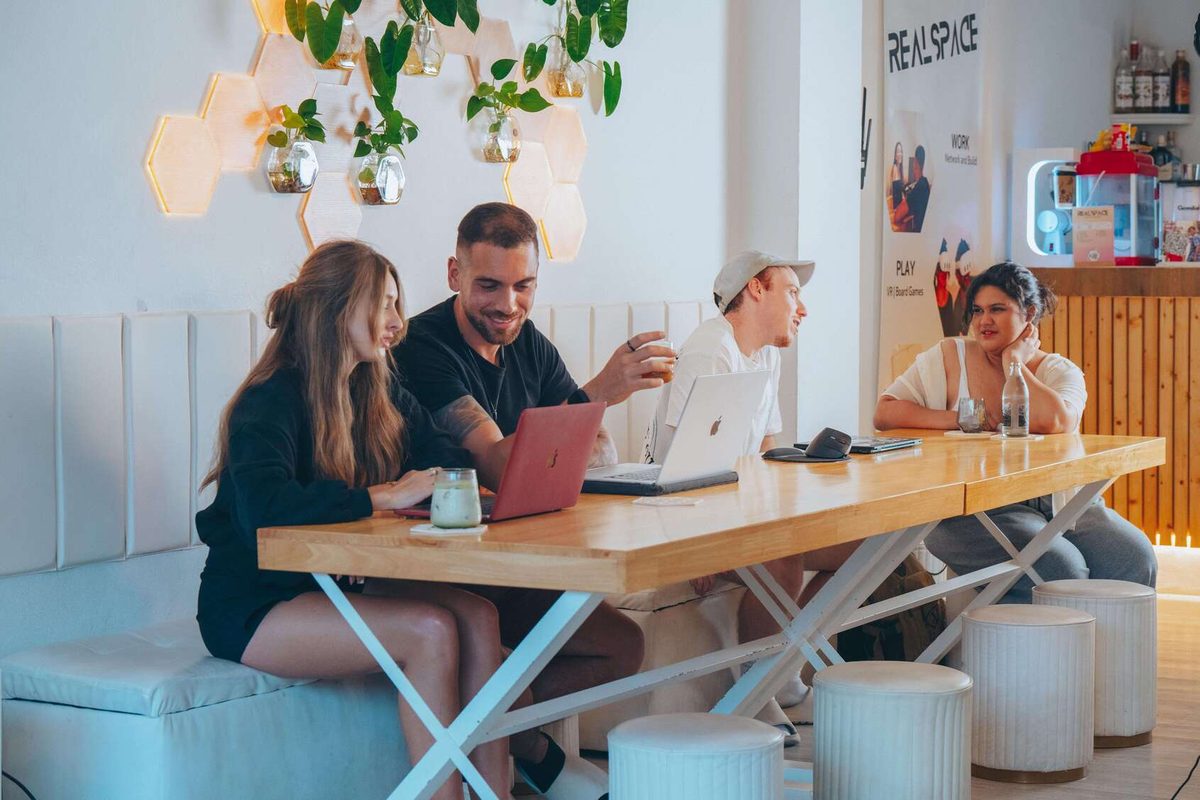 Members laughing together at a long table